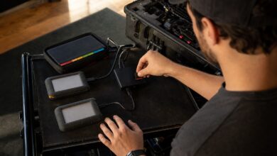 Responsable de datos inserta una tarjeta de cámara en un lector junto a dos discos de copia y una cartera de soportes